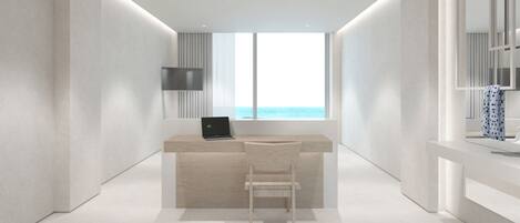 A modern, minimalist room with a desk, chair, and a large window offering a view of the sea.