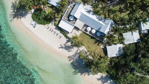 An aerial view of a beachfront property with a large house, a swimming pool, and a beach. - Holiday Inn Mauritius Mon Tresor by IHG (Plaine Magnien)
