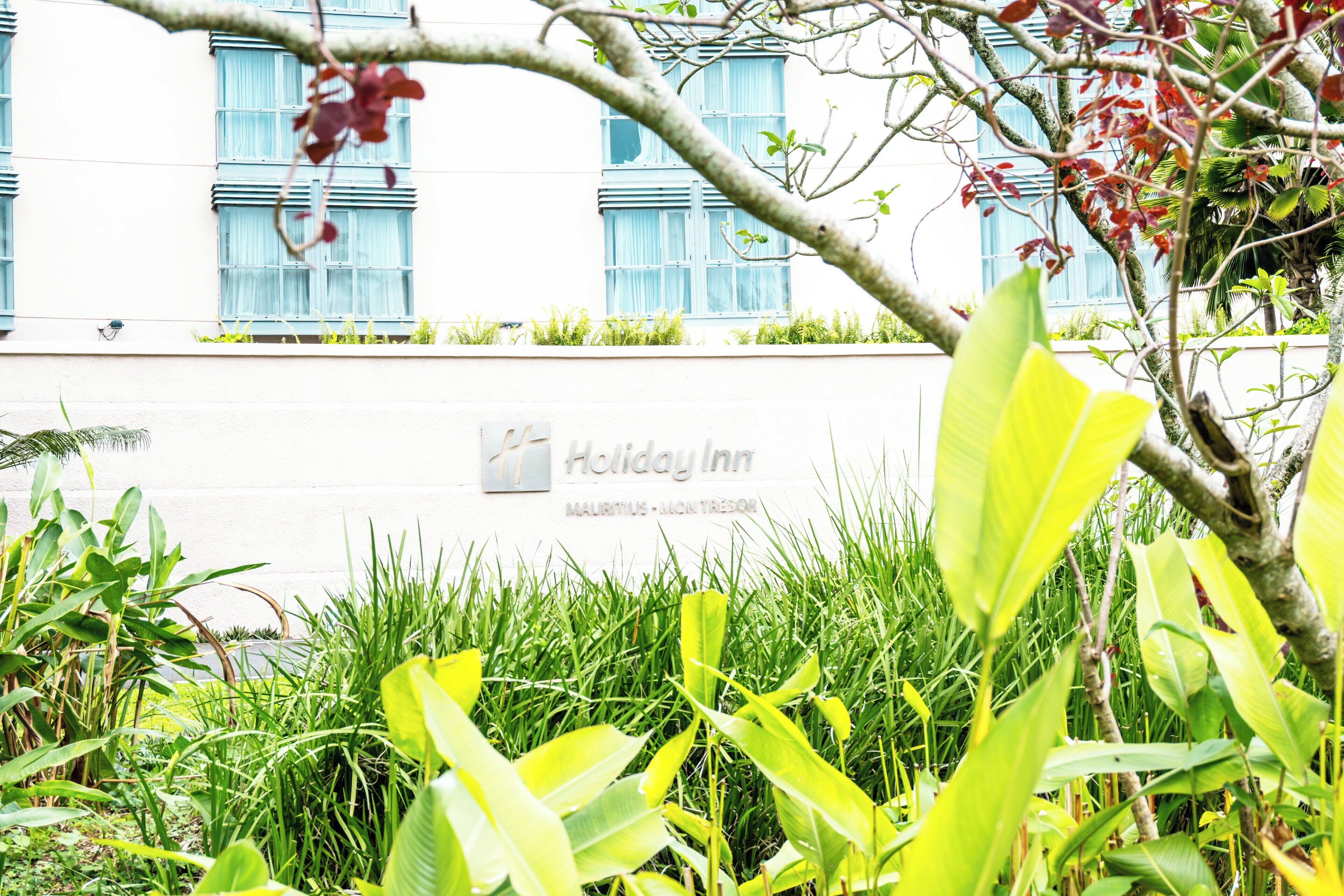 A building with a sign for Holiday Inn Mauritius-North Island.