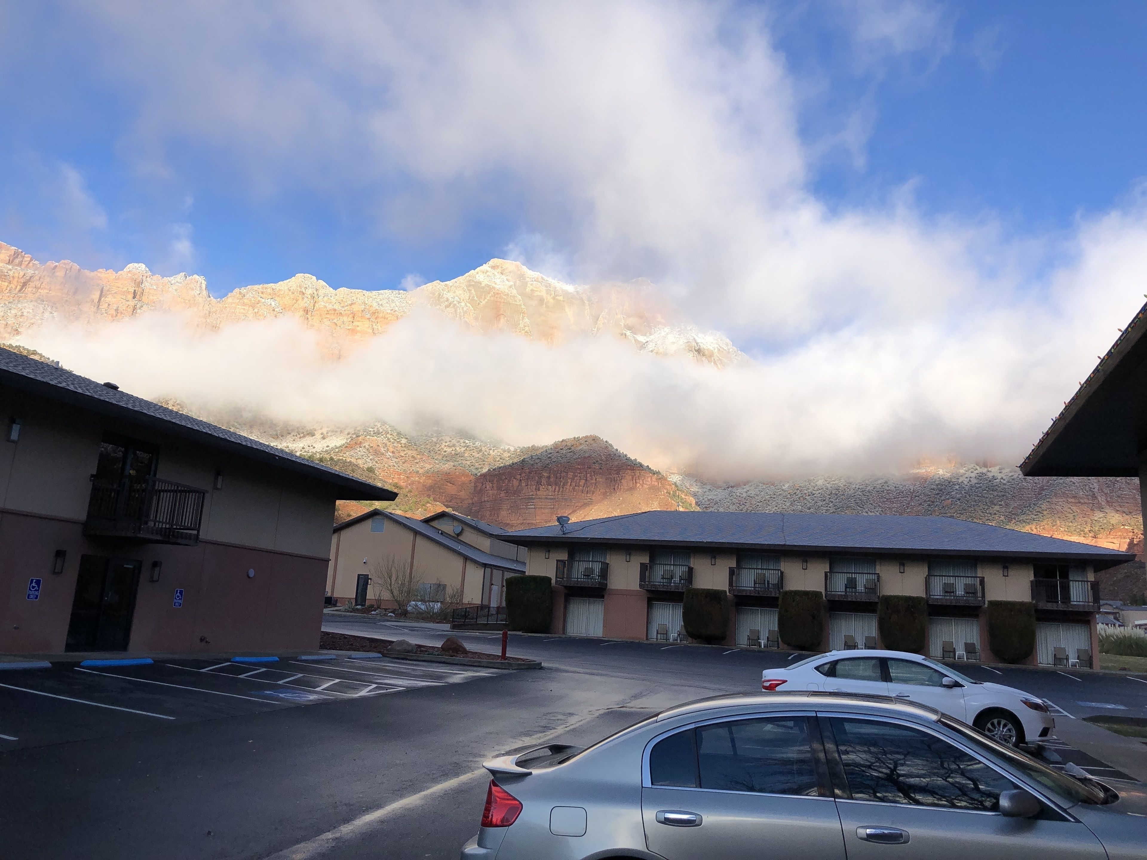 A parking lot with a mountain in the background.