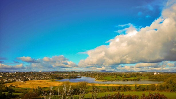 A panoramic view of a river valley with a town, fields, and a large body of water. - Samuel's Heritage Bed & Breakfast (Waterford)