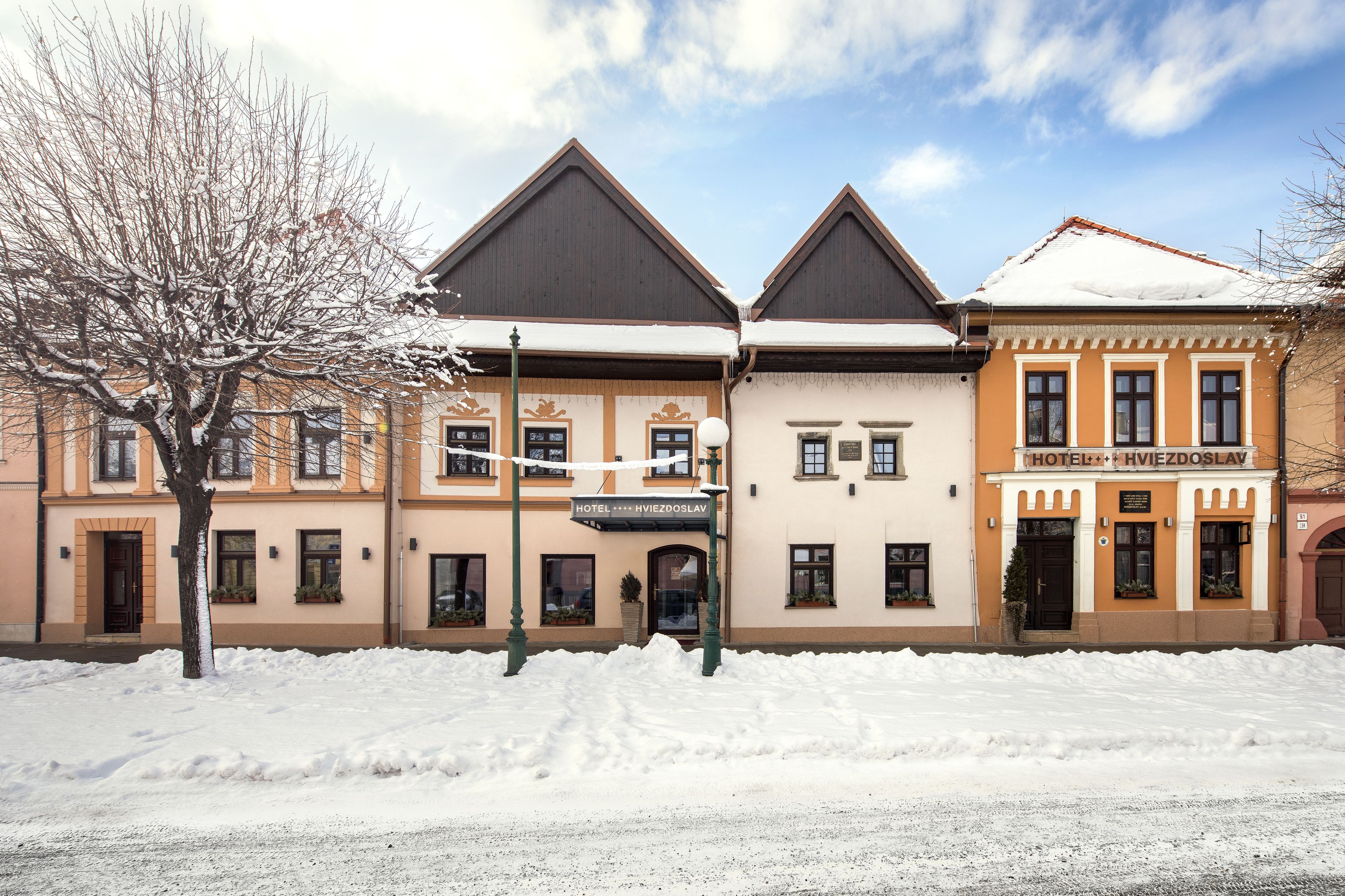 A hotel with a traditional architectural style, featuring a symmetrical facade with two main sections.