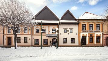 A hotel with a traditional architectural style, featuring a symmetrical facade with two main sections.