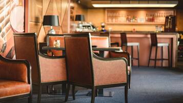A bar area with leather chairs and a bar counter.