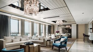 A modern hotel lobby with a sofa, chairs, a coffee table, and a chandelier. - Langham Place Xiamen (Xiamen)