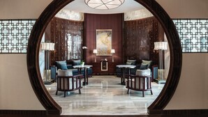 A luxurious lobby with a large wooden archway, marble flooring, and modern furniture. - Langham Place Xiamen (Xiamen)