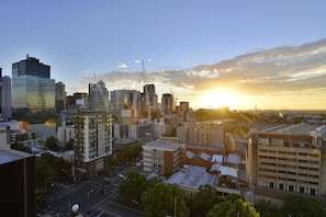 A cityscape with modern buildings and a sunset. - Mercure Melbourne Therry Street (Melbourne)