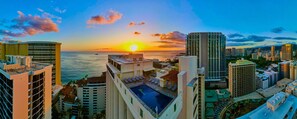 A high-rise hotel with a rooftop pool and ocean views at sunset. - The Imperial Hawaii Resort (Honolulu)