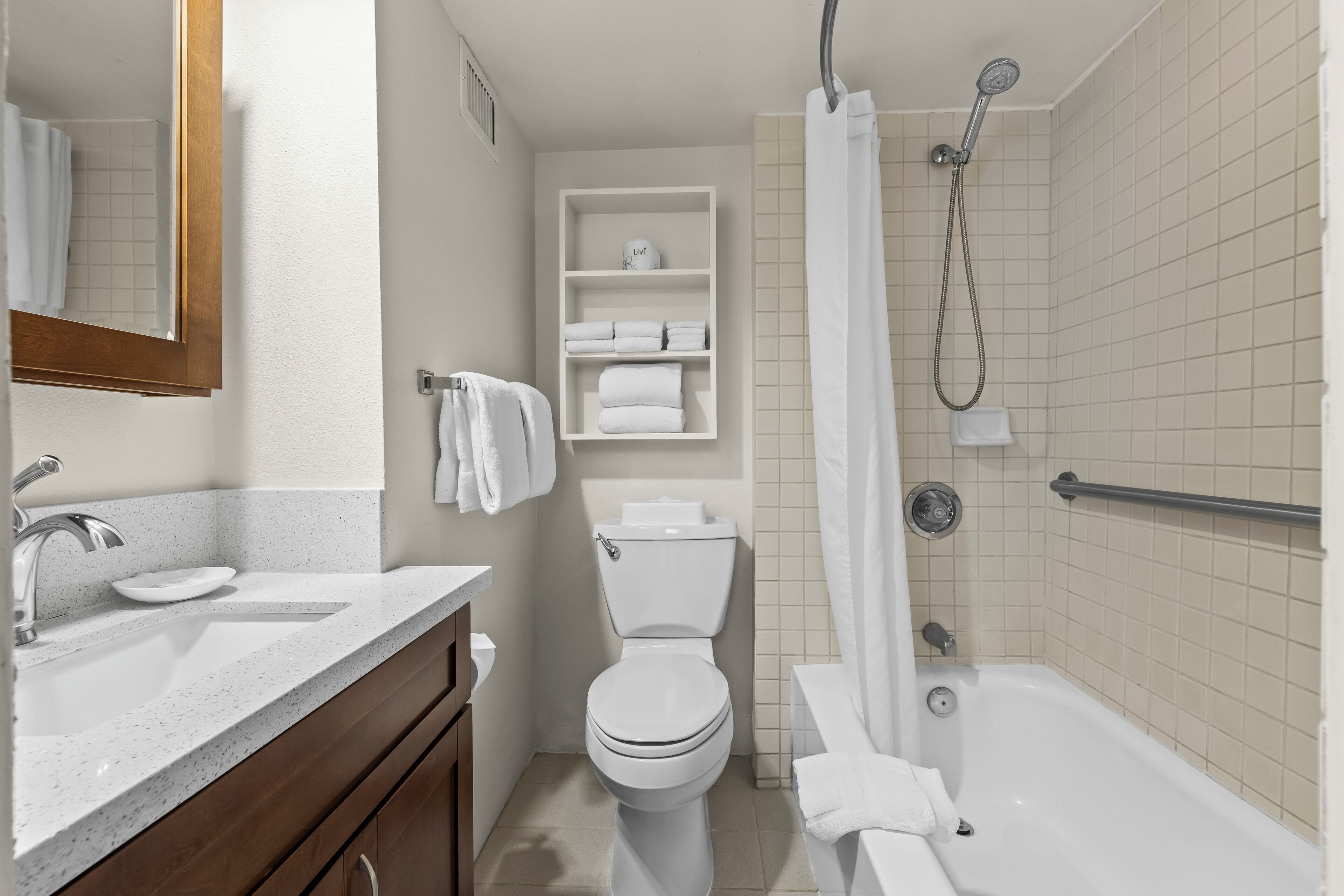 A modern bathroom with a sink, toilet, and shower.