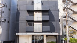 A modern hotel with a geometric facade, large windows, and a visible entrance. - Hotel AreaOne Fukuyama (Fukuyama)