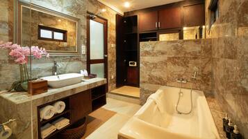 A modern bathroom with a marble sink, a large bathtub, and a walk-in shower.
