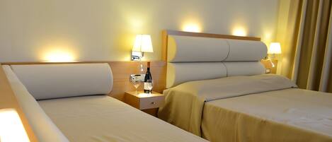 Triple Room | Minibar, in-room safe, individually furnished, desk