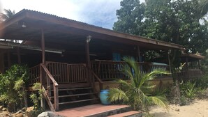 A wooden building with a porch, steps, and a covered area. - Bang Po Village (Koh Samui)