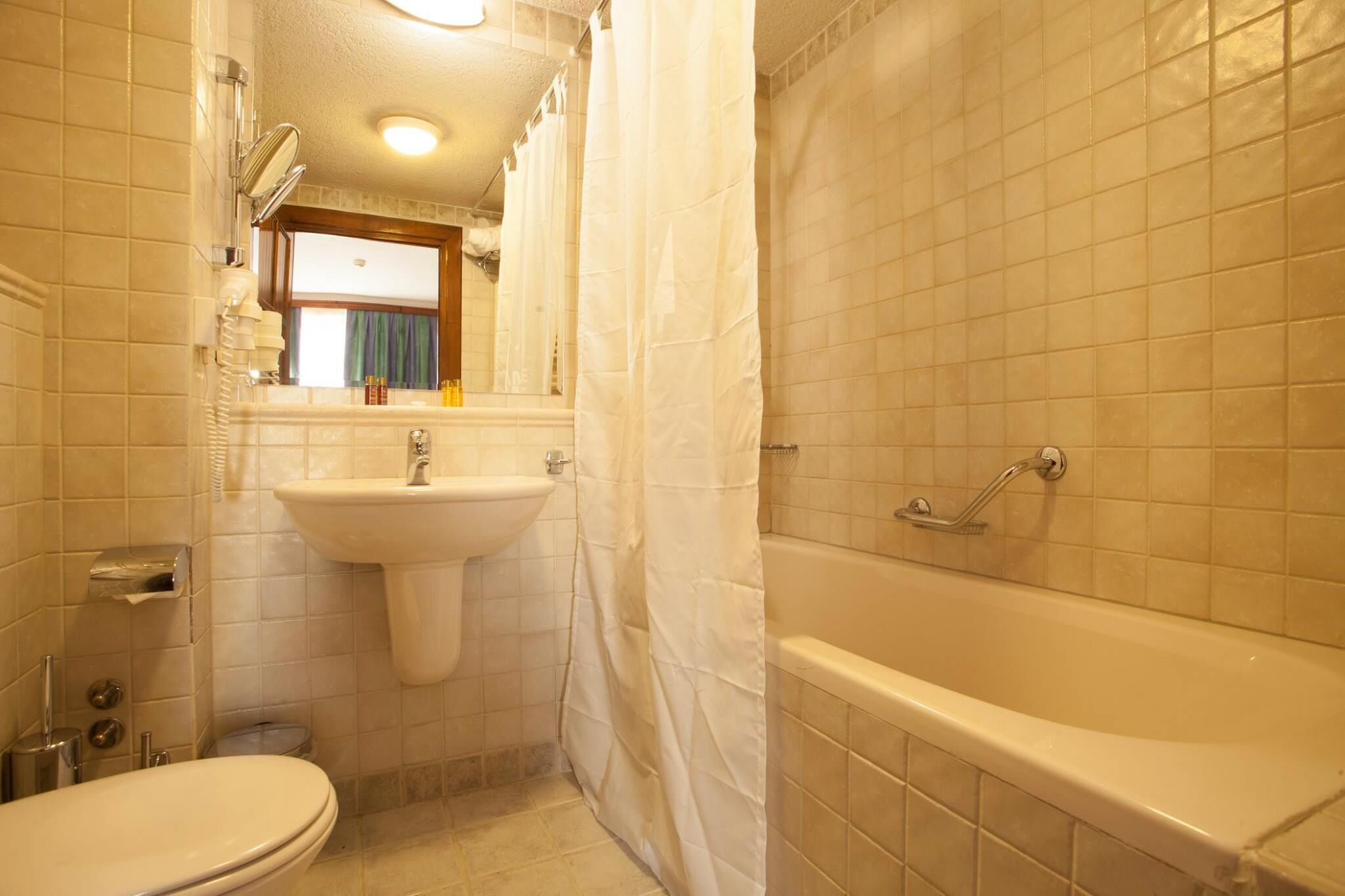 apartment, 1 bedroom (free safe, parking & spa access) | bathroom | combined shower/bathtub, hair dryer, towels
