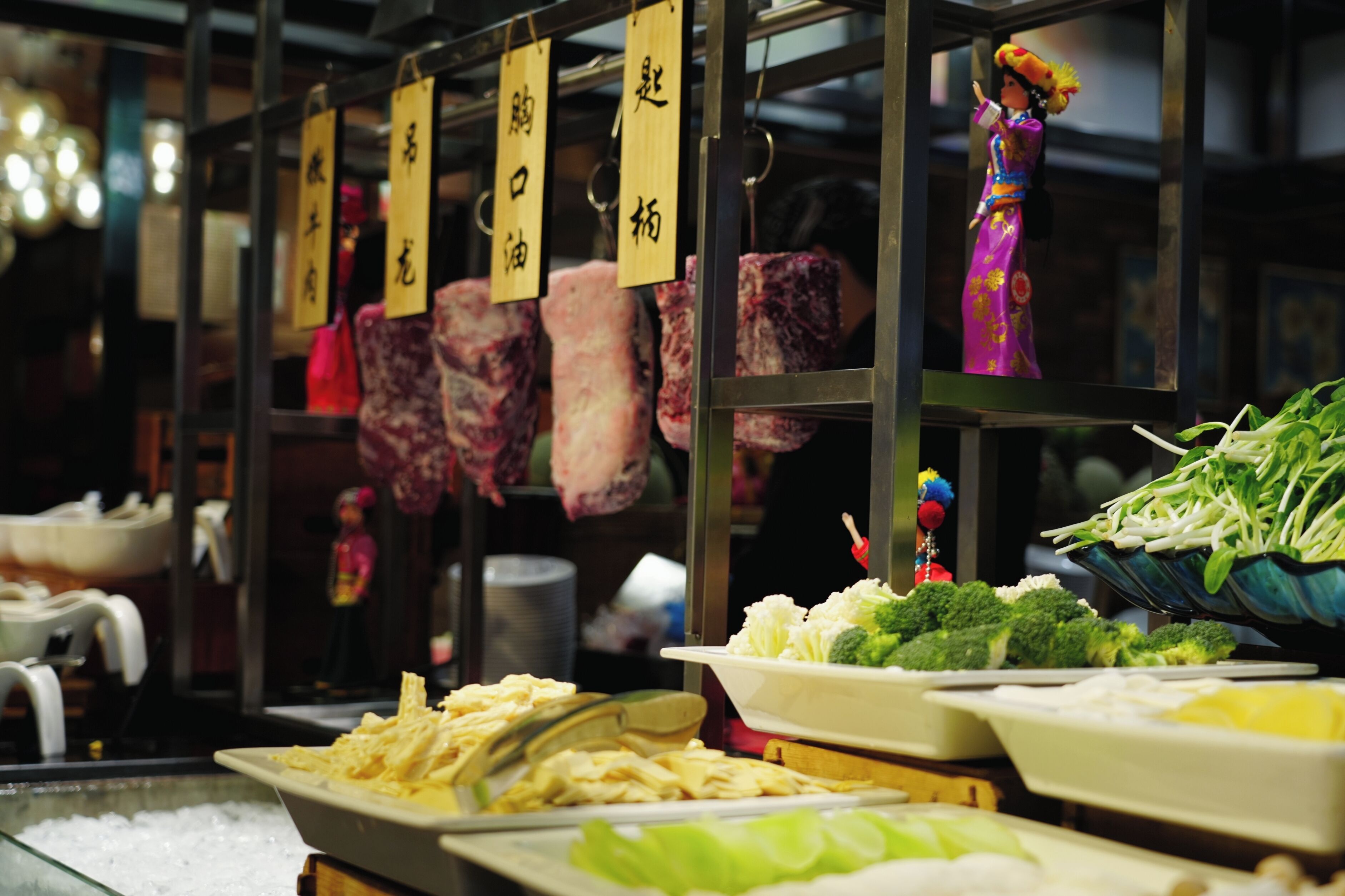 A variety of meats and vegetables displayed in a market setting.