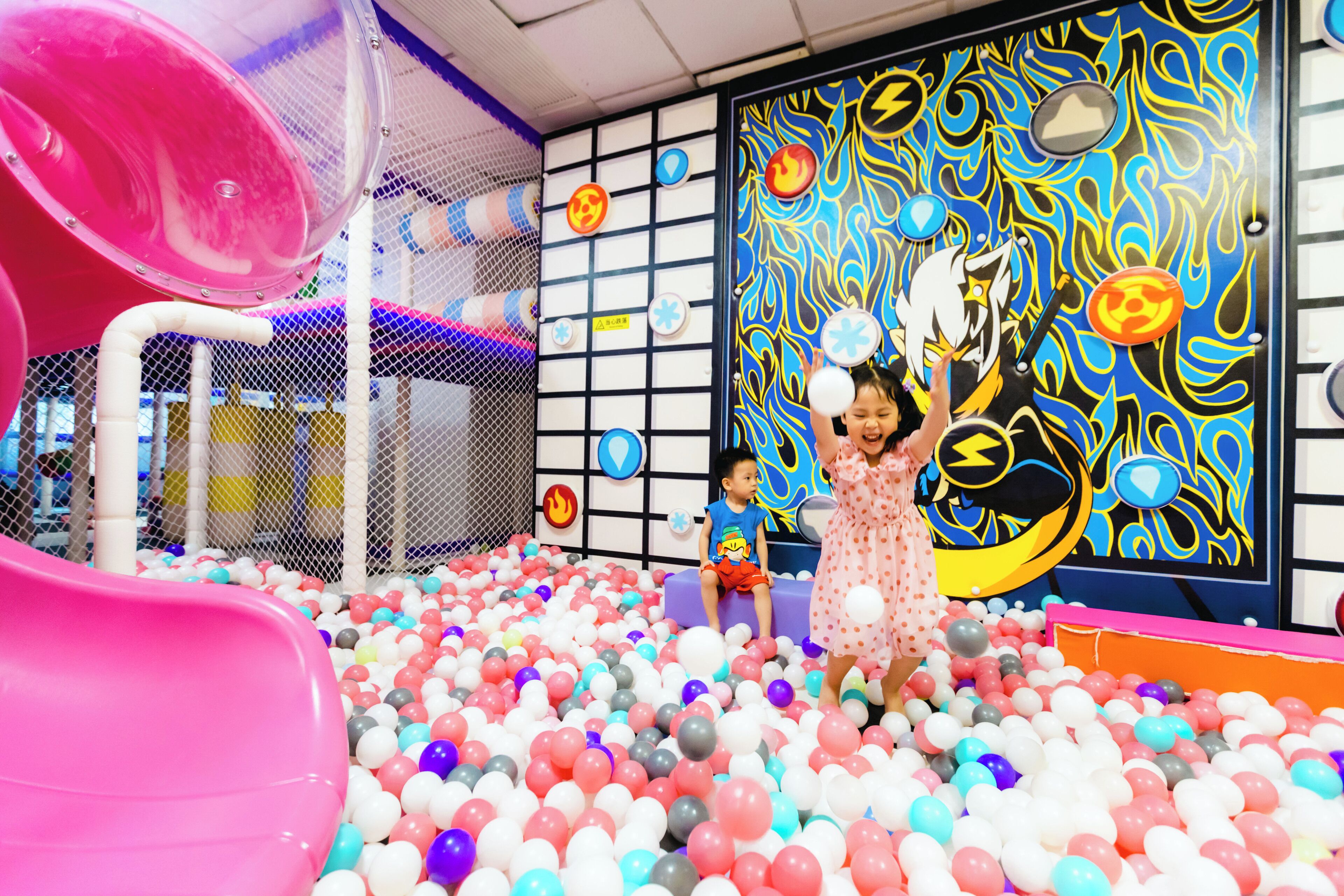 A play area with a ball pit and a slide.
