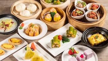 A variety of Asian dishes including dumplings, spring rolls, and desserts.