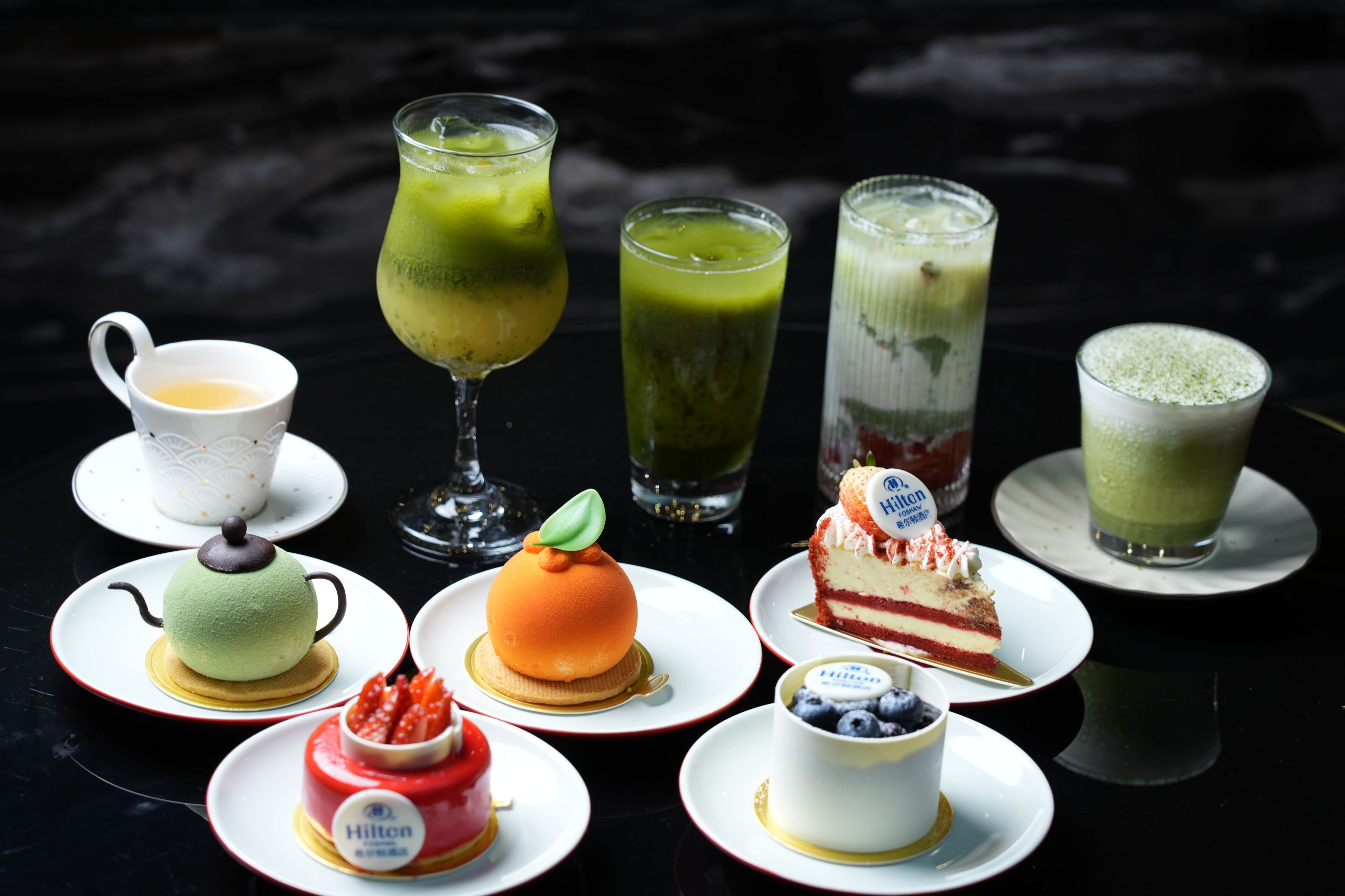 A variety of desserts and beverages on a table.