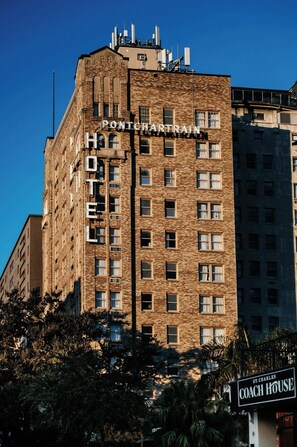 A hotel building with a sign reading 'PONTCHARTRAIN HOTEL' and another sign for 'ST. CHARLES COACH HOUSE' in the foreground. - The Pontchartrain Hotel (New Orleans)