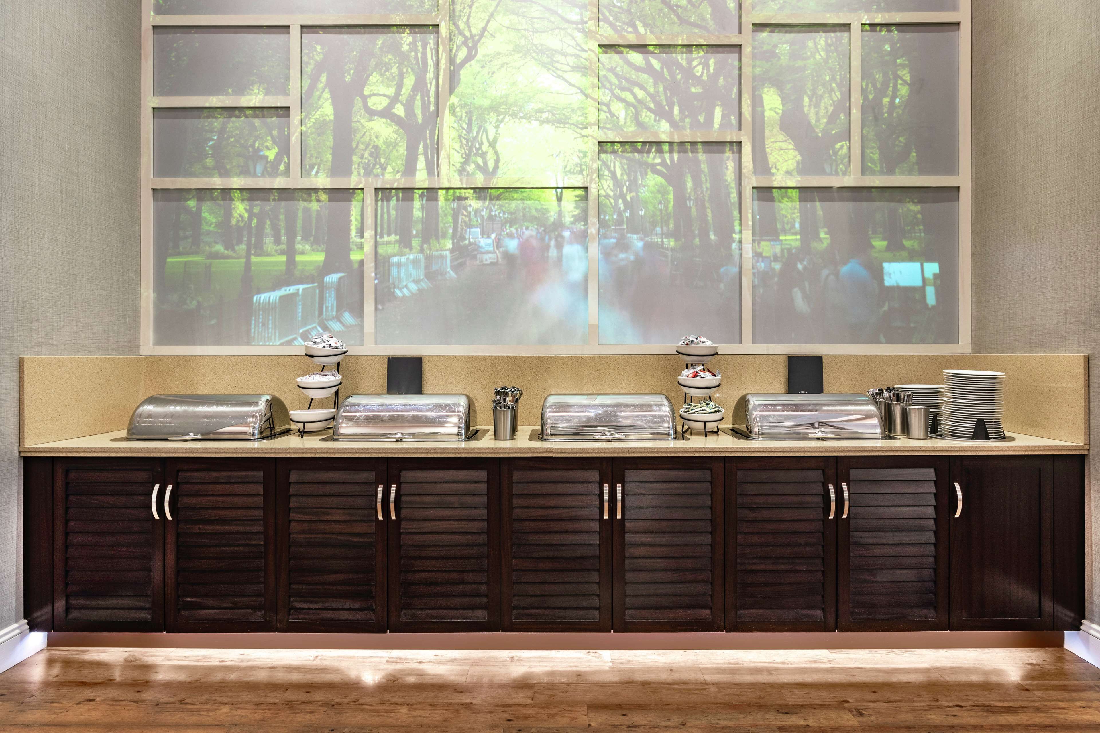 A breakfast bar with a projection of a forest scene, a toaster, and a coffee maker.