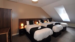 A hotel room with two beds, a desk, and a skylight. - May's House (Liverpool)