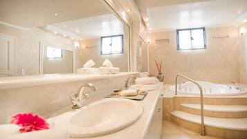A modern bathroom with a large mirror, a sink, a bathtub, and a shower.