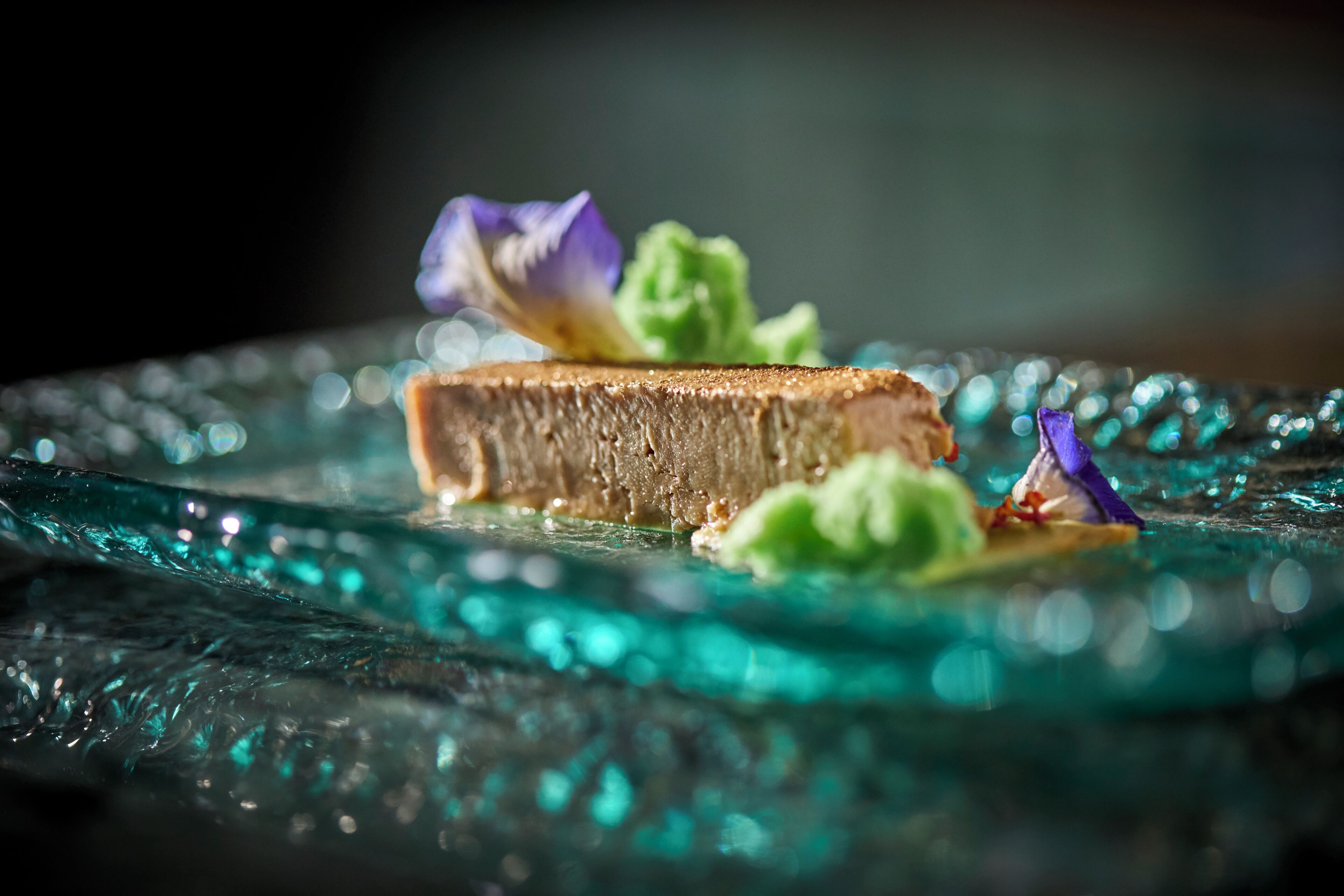 A dessert on a glass plate with a blurred background.