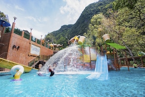 A water park with a pool, slides, and a mountain backdrop. - Sunway Lost World Hotel (Ipoh)