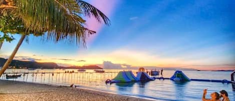 On the beach, white sand, sun-loungers, beach umbrellas