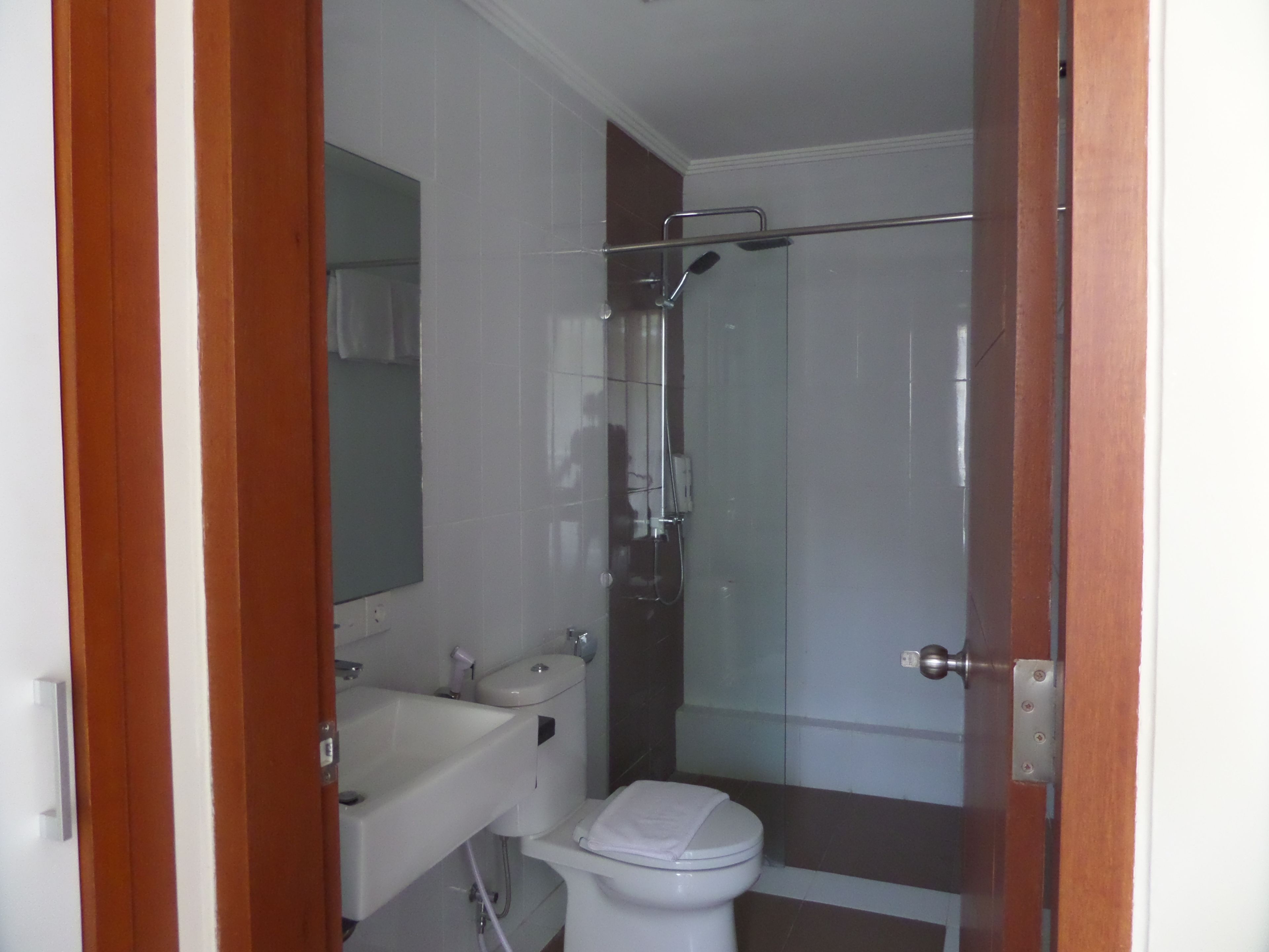 A bathroom with a toilet, sink, and shower.