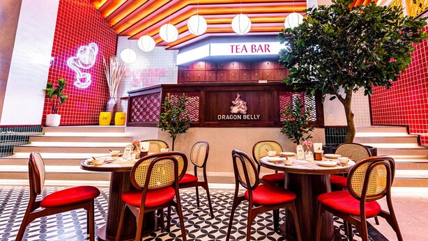 A restaurant with a red and white color scheme, featuring a Dragon Belly sign and a Tea Bar sign. - Mood Hotel Pattaya (Pattaya)