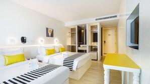 A hotel room with two beds, a TV, a desk, and a bathroom visible through an open door. - Mood Hotel Pattaya (Pattaya)
