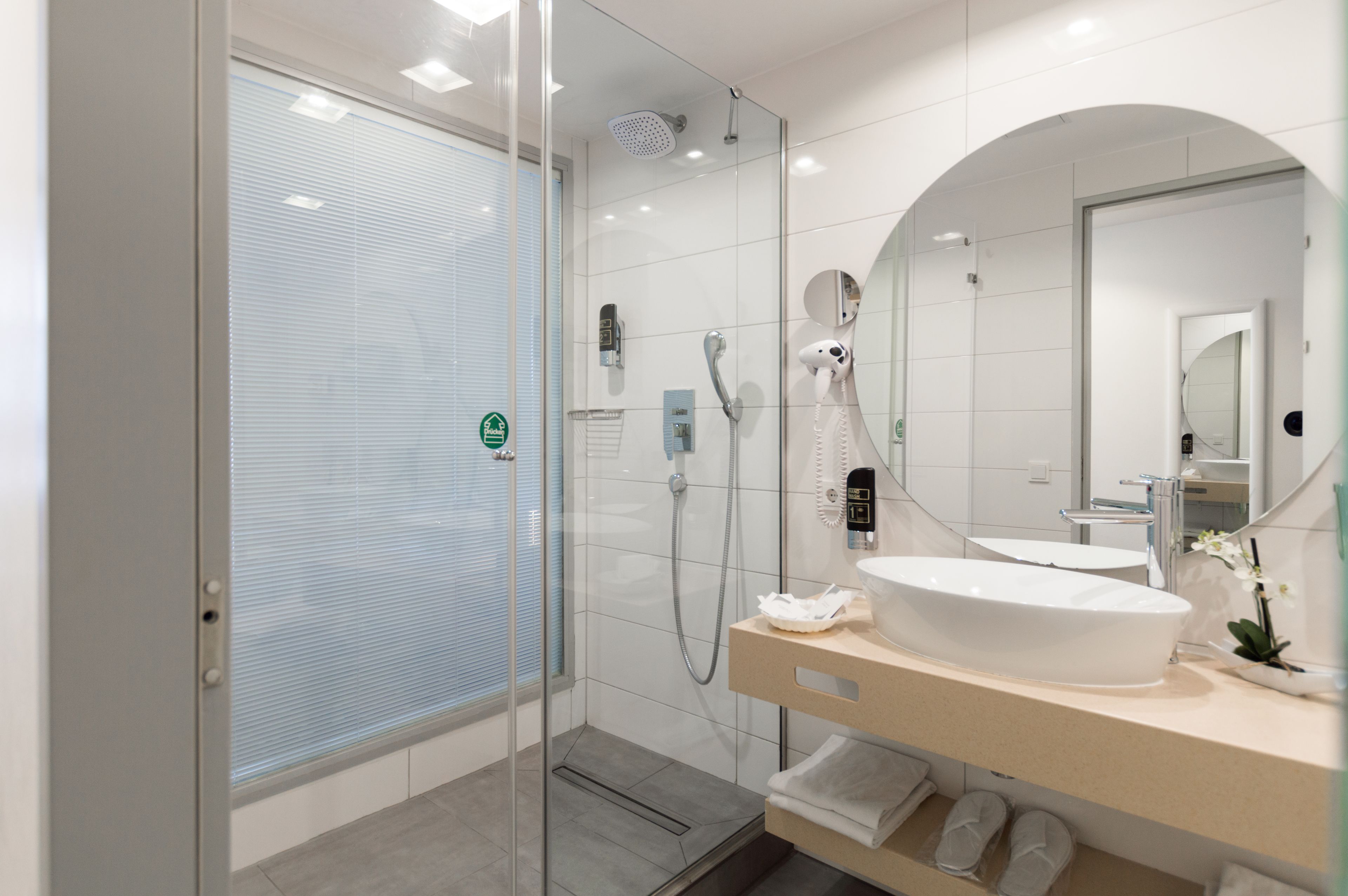 shower, hair dryer, slippers, towels