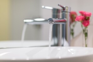 Shower, hair dryer, slippers, towels