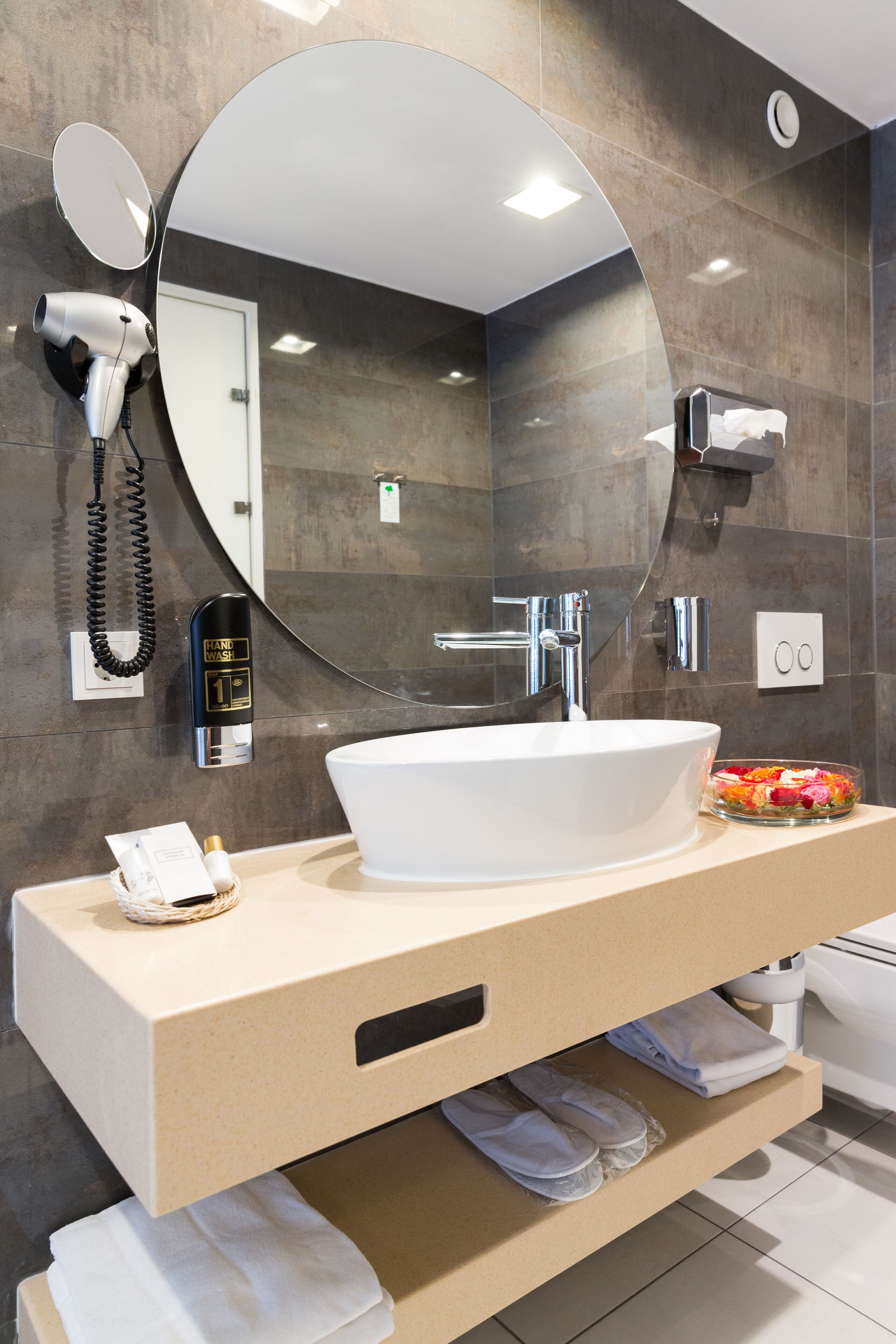 shower, hair dryer, slippers, towels