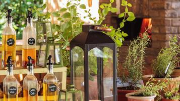An outdoor dining area with pizza, candles, and potted plants.