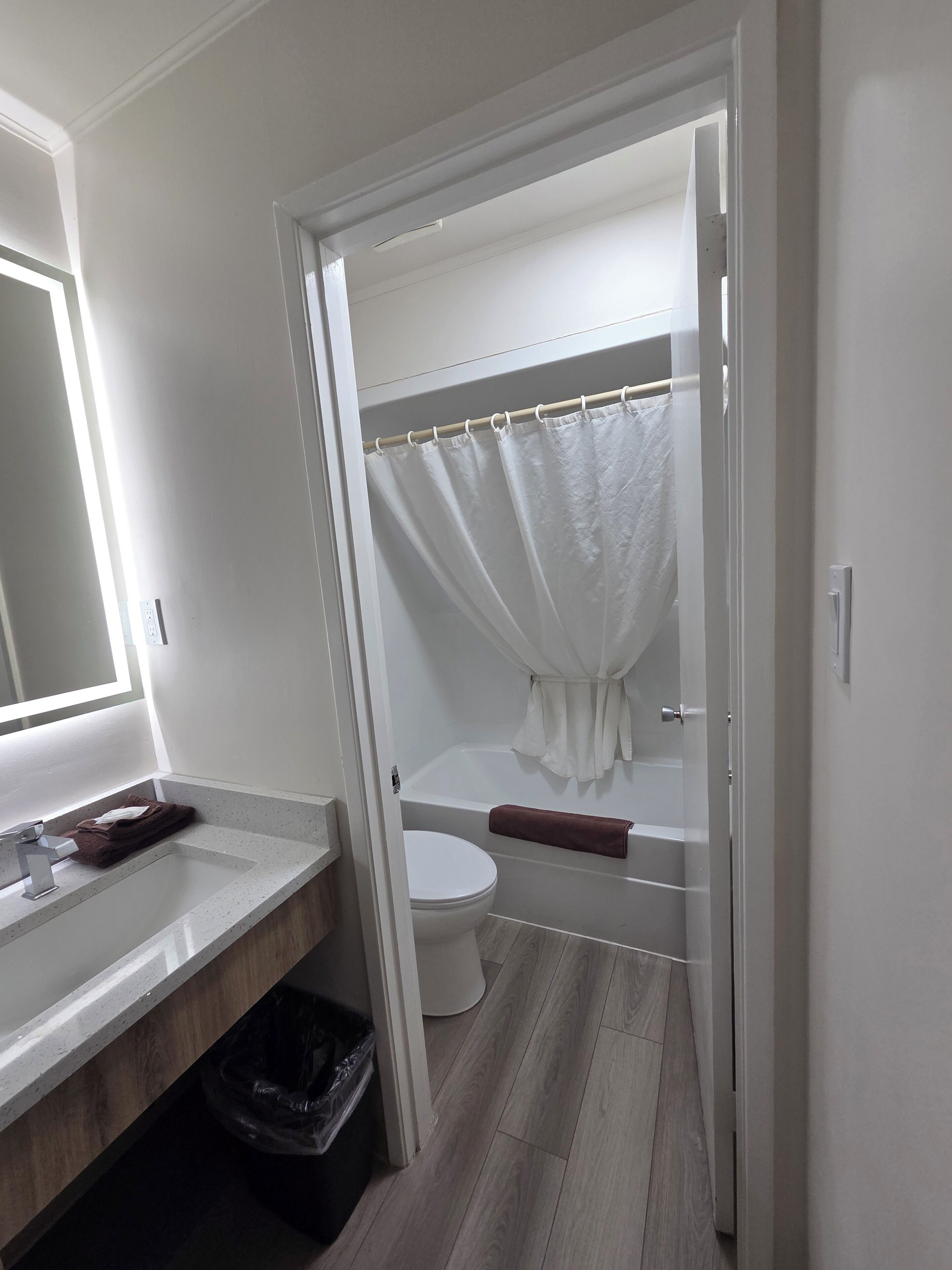 A bathroom with a toilet, sink, and bathtub.