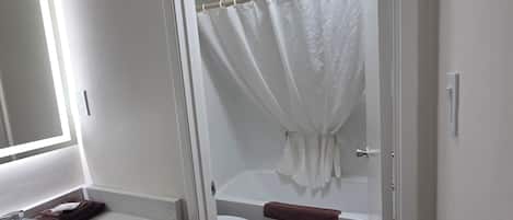 A bathroom with a toilet, sink, and bathtub.