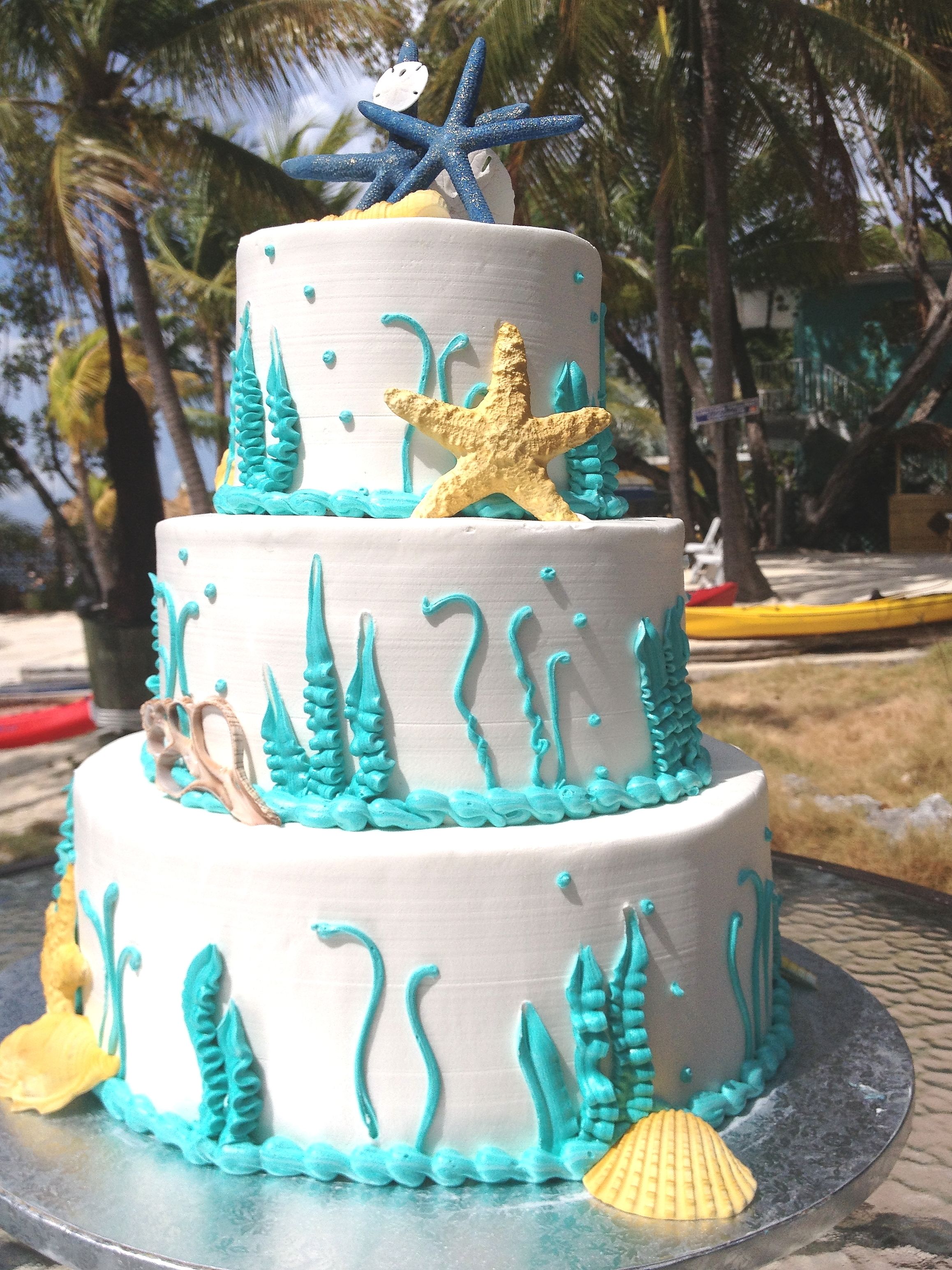 A three-tiered cake with sea-themed decorations.