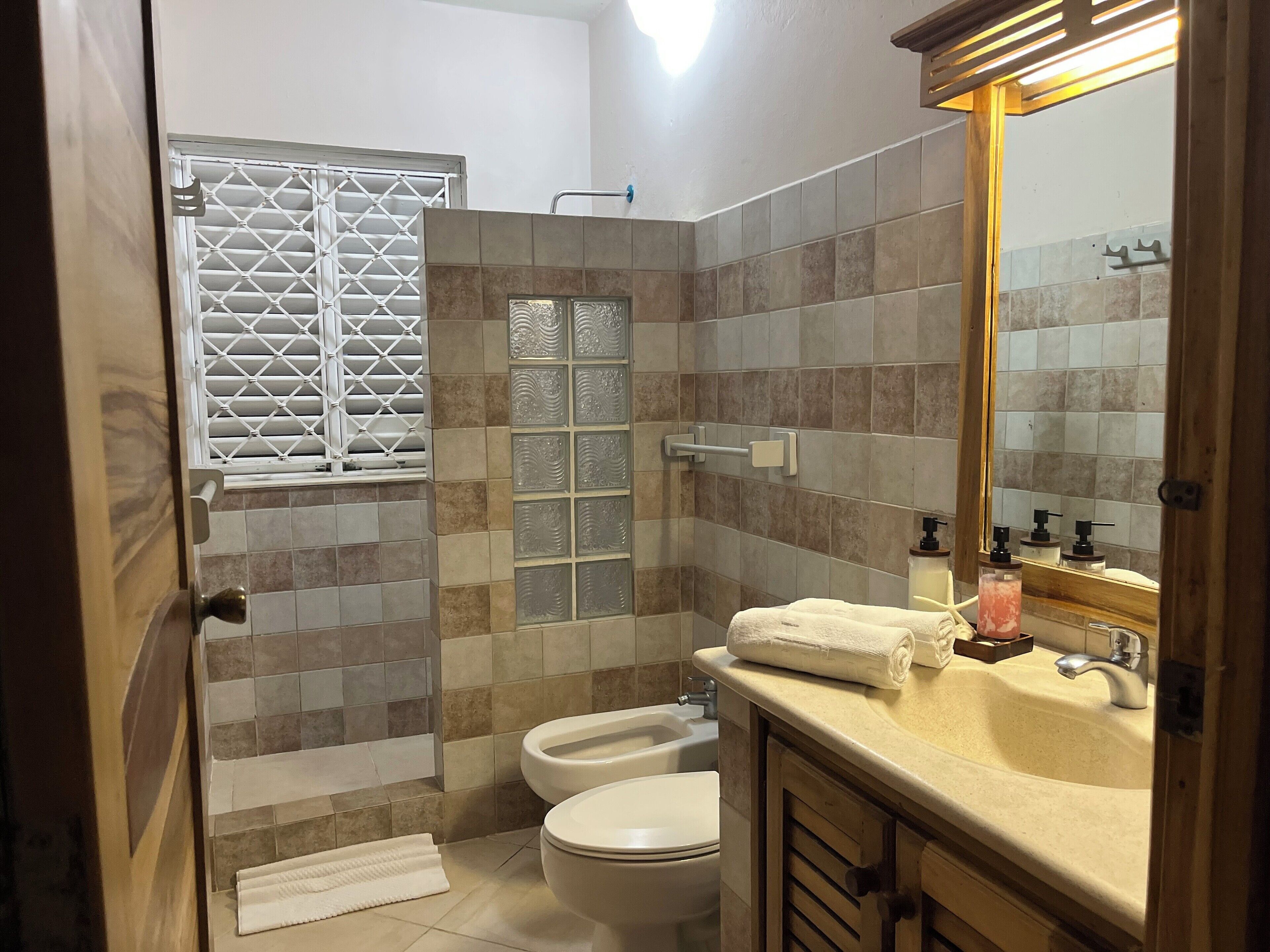 deluxe room | bathroom | rainfall showerhead, designer toiletries, hair dryer, bidet