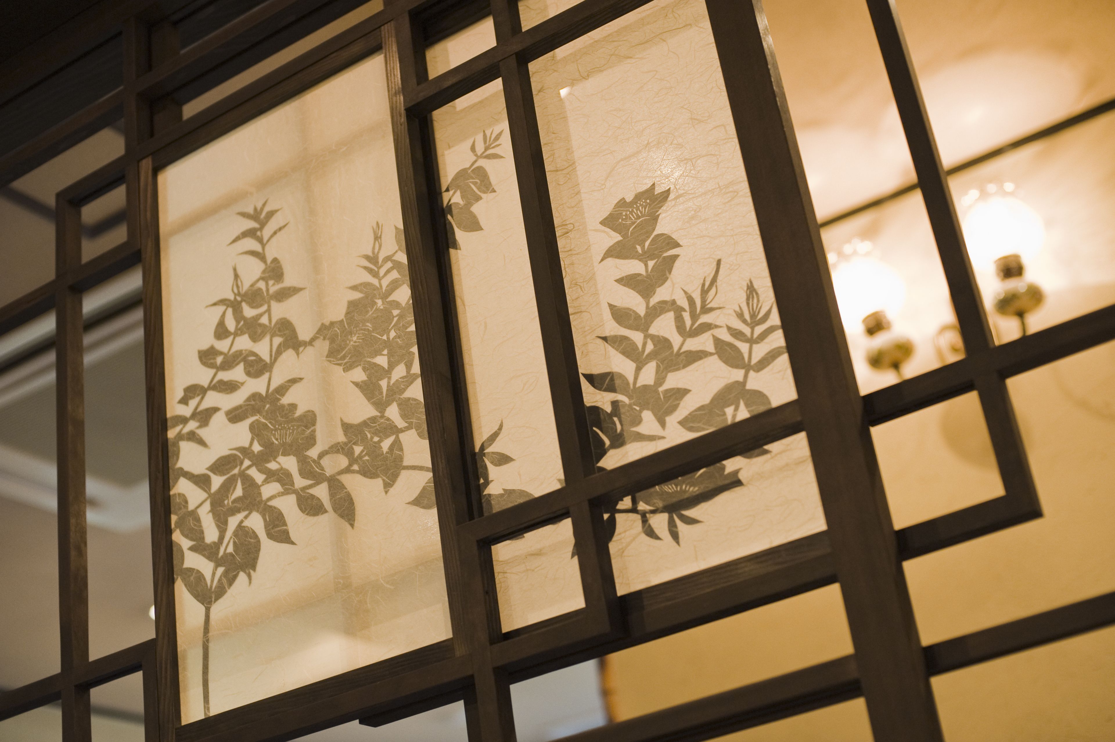 A window with a geometric pattern and a floral design.