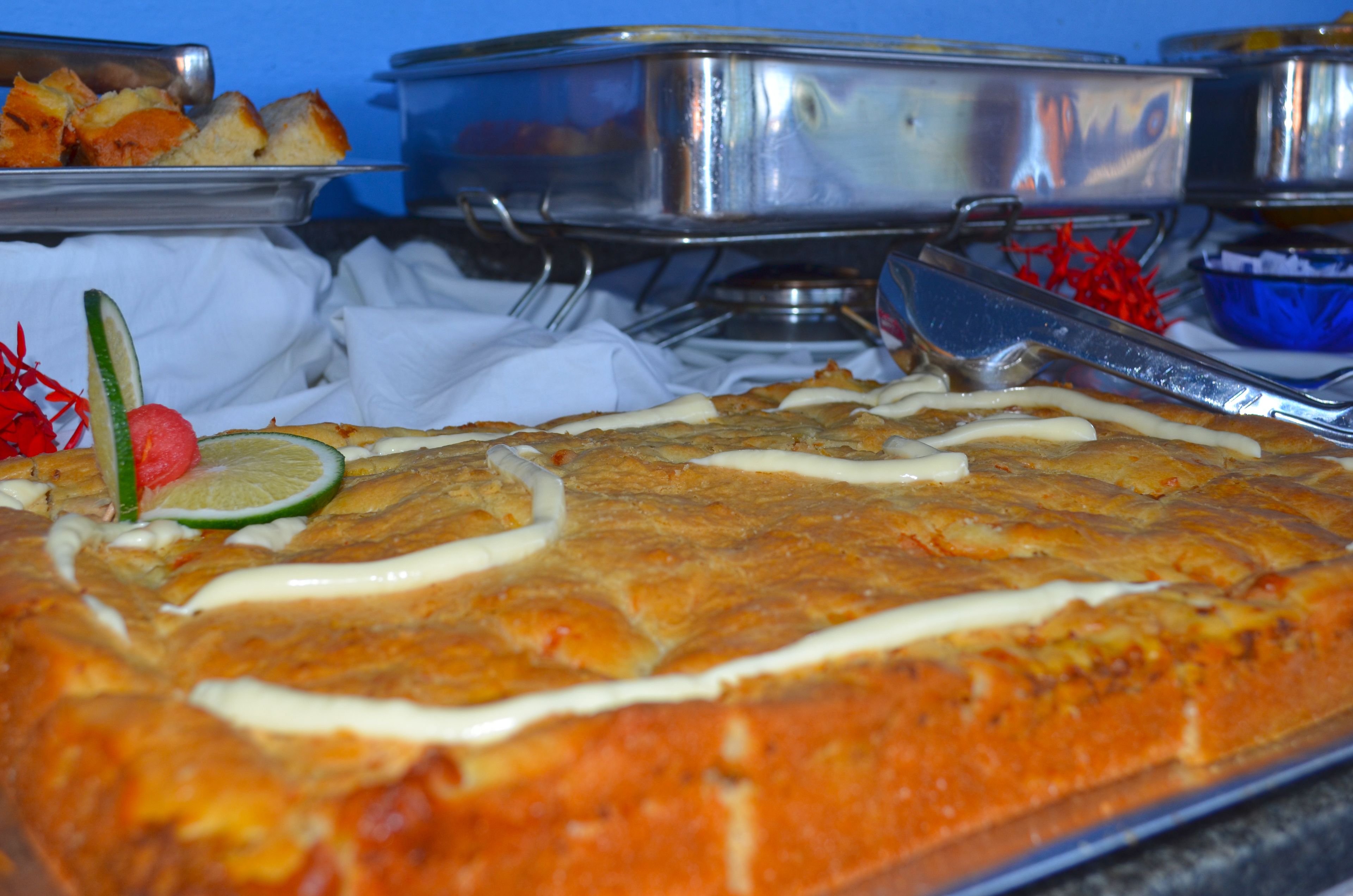 A large, rectangular cake with white icing on a metal tray.