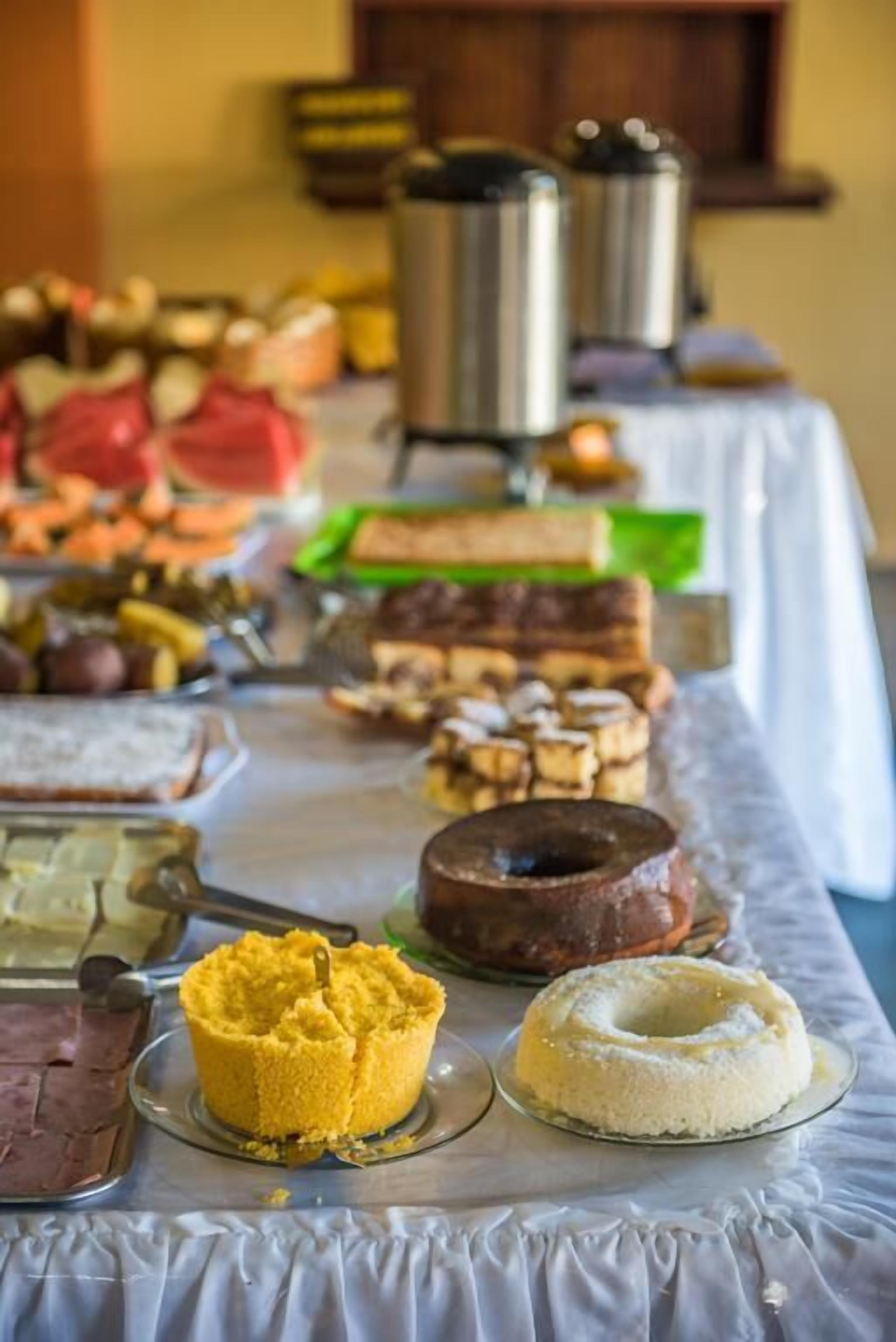 A buffet table with various food items and a coffee station.