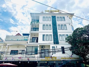 A multi-story building with a sign for 'The Unique Angkor Villa' indicating it is a hotel and restaurant. - The Unique Angkor Villa (Siem Reap)