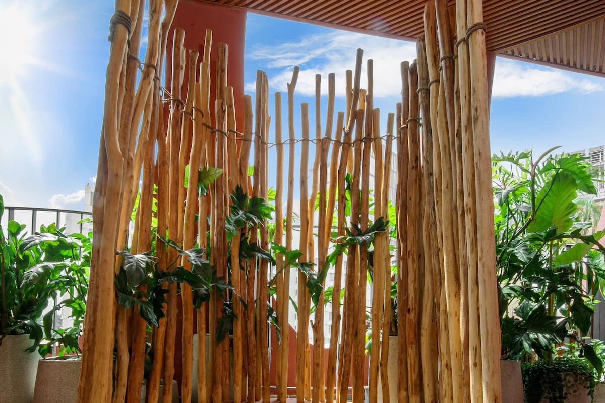 A circular seating area with a wooden fence and potted plants.