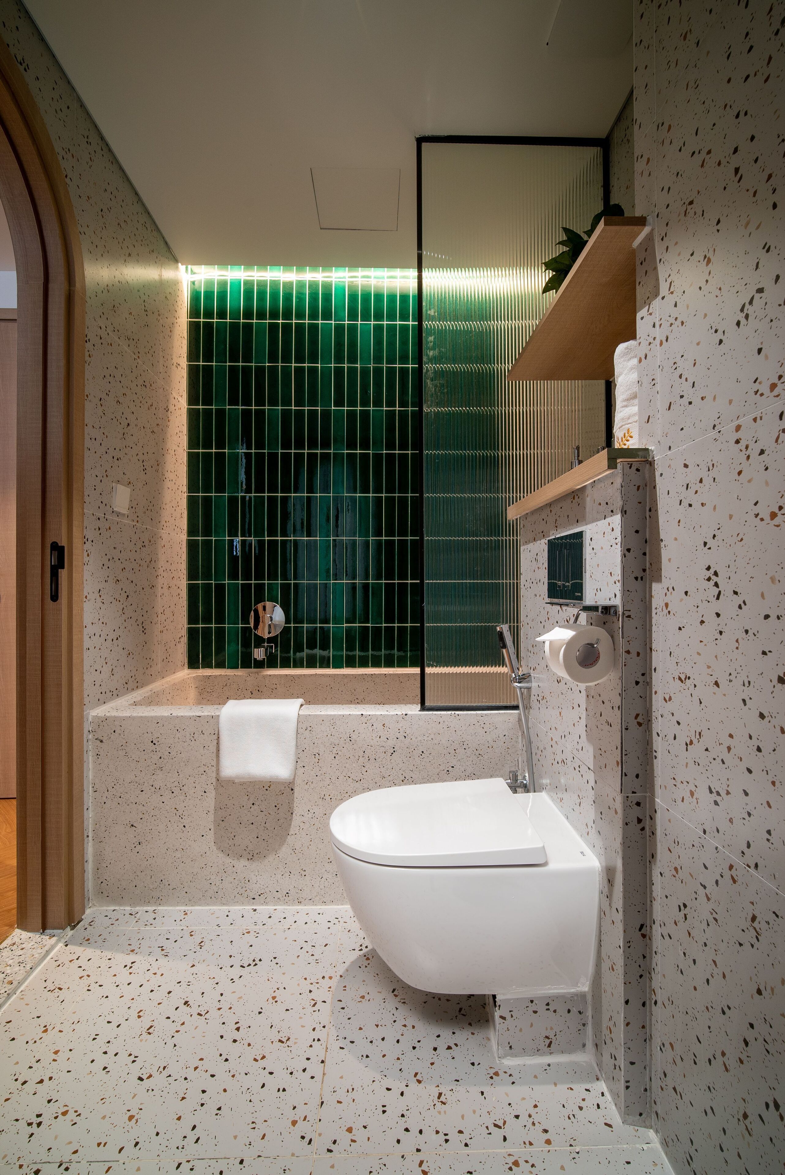 A modern bathroom with a freestanding bathtub, a sink, and a mirror.