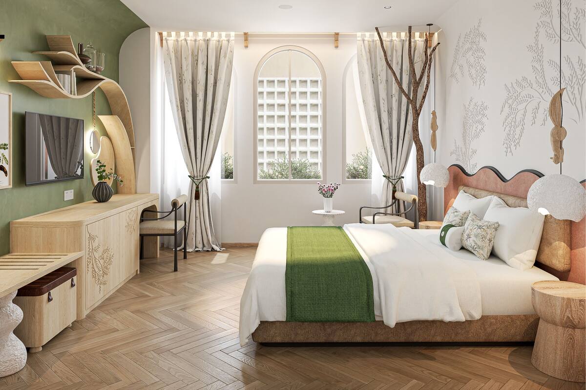 A bedroom with a bed, a desk, a chair, a vanity, and a window with curtains.