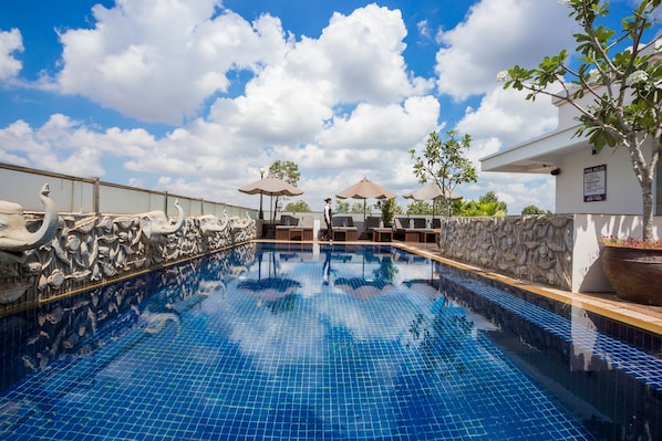 Outdoor pool, a rooftop pool, pool umbrellas, pool loungers