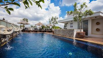 Outdoor pool, a rooftop pool, pool umbrellas, sun loungers