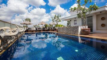 Outdoor pool, a rooftop pool, pool umbrellas, sun loungers